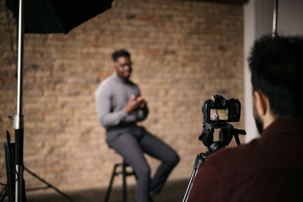 istock Cameraman recording an interview in a studio 1396913577