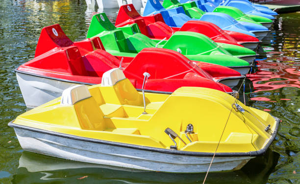istock Colorful plastic catamarans are in a row on the water surface 1396914510