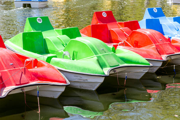 istock Colorful plastic catamarans are in a row on the water surface 1396914520