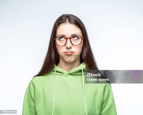 Bored Woman In Hooded Shirt Against White Background Stock Photo - Download Image Now