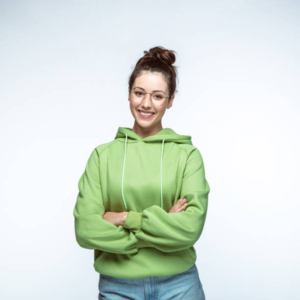 istock Happy woman standing with arms crossed 1396915547