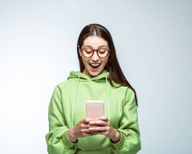Happy woman using phone over white background