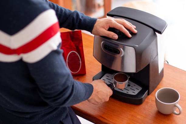 istock Unknown man preparing coffee in his own ground coffee machine. 1396915827