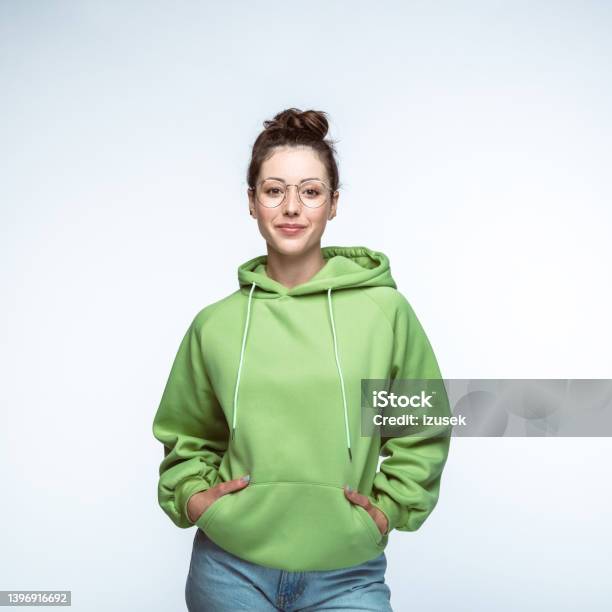 Woman Standing With Hands In Pockets Stock Photo - Download Image Now - Cut Out, Hooded Shirt, People