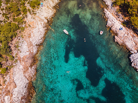 Aerial view of beautiful small beach on the Greek island Thassos, rocky coastline with turquoise sea