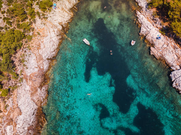 Aerial view of beautiful small beach on the Greek island, rocky coastline with turquoise sea stock photo