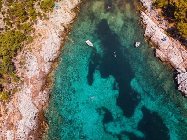 Photo of Aerial view of beautiful small beach on the Greek island, rocky coastline with turquoise sea