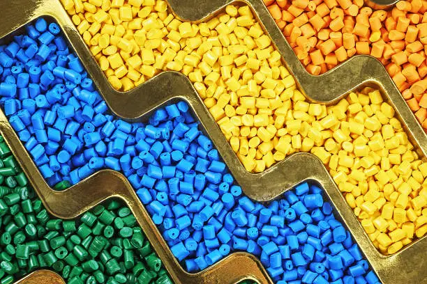 Photo of Plastic granules. Polymer pellets. Polymeric dye. Colorant pellets.