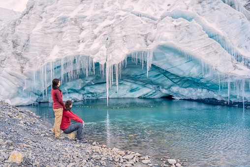 Tourist couple looking at Pastoruri glacier cave