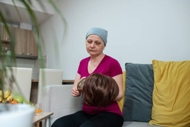 istock Cancer patient brushing her wig at home 1396921109