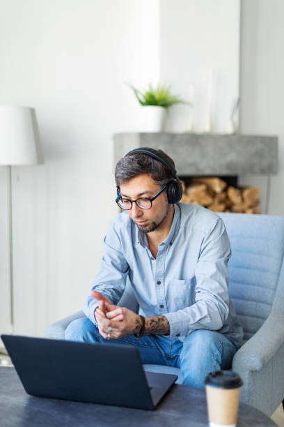 istock Young freelancer working from home with laptop  and having video call 1396921647