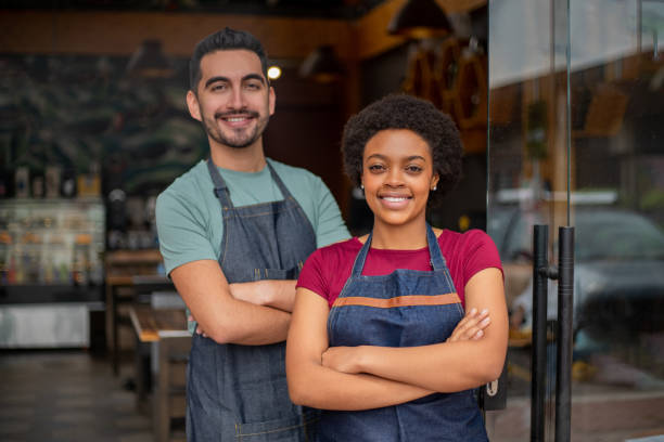 istock Happy team of waiters working at a restaurant 1396921736