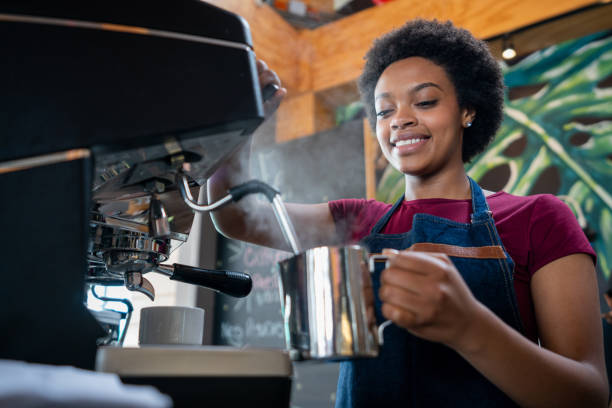 istock Happy barista making a capuccino at a cafe 1396921774
