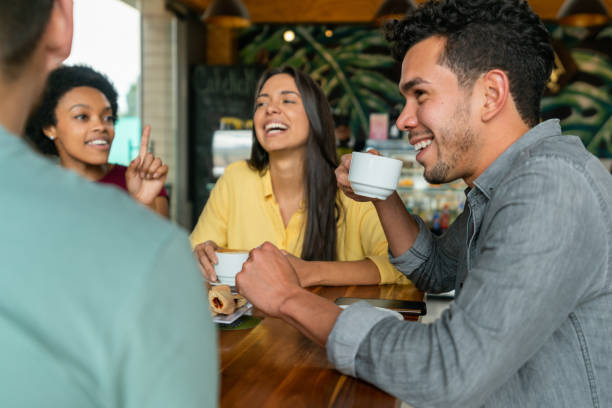 istock Happy group of friends having fun talking at a cafe 1396921831