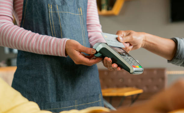 istock Man making a contactless payment to a waitress at a restaurant 1396921844