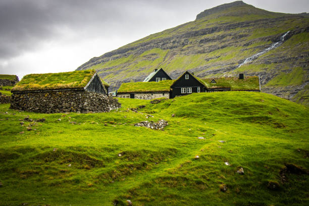 istock solitary village on Faeroe Islands, mountains 1396921904