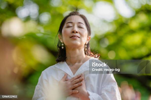 Woman Meditating In Nature Stock Photo - Download Image Now - Women, Breathing Exercise, One Woman Only