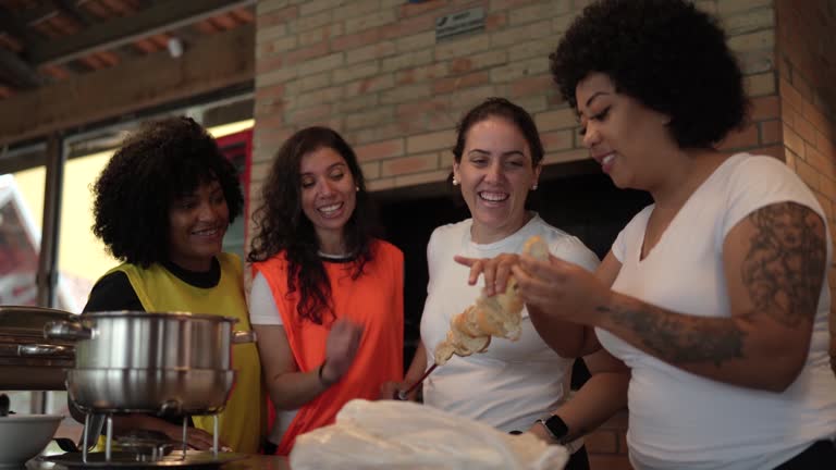 Women having barbecue after football