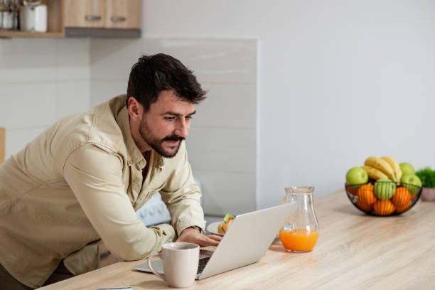 istock Handsome young man working from home, early in the morning 1396923480