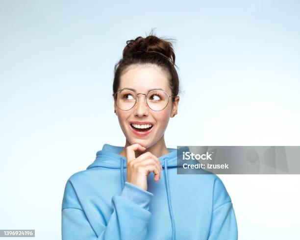 Thoughtful Young Woman In Hooded Shirt Stock Photo - Download Image Now - Eyeglasses, Front View, Human Face