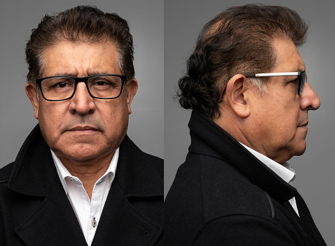 Hispanic senior man front and profile mugshots on gray background