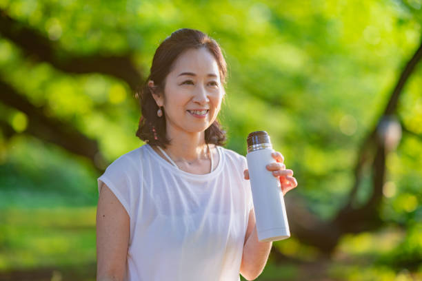 istock Female yoga practitioner taking a break and having water. She is using reusable water bottle. 1396924641