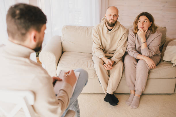istock Psychiatrist consulting couple that have problems in their relationship. Mental support session. 1396924746