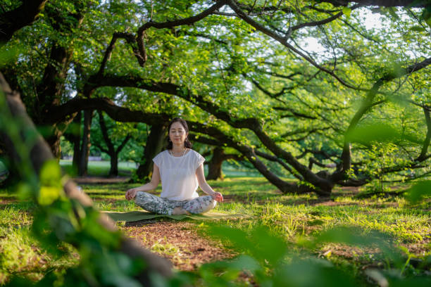 istock Woman meditating in nature 1396924784
