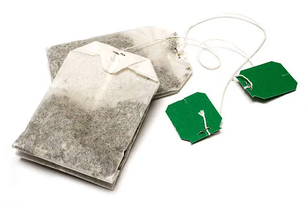 Two tea bags on a white background.