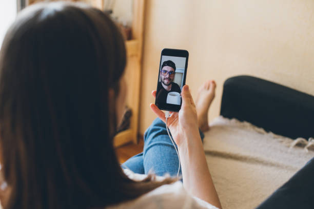 istock Young woman doing video chat with men at home. 1396925820
