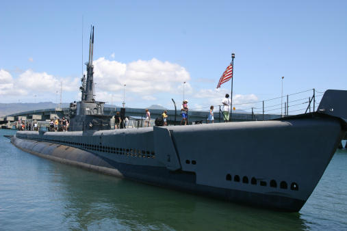 Navy frigate moored at naval dockyard.