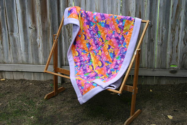 baby quilt on quilt stand stock photo