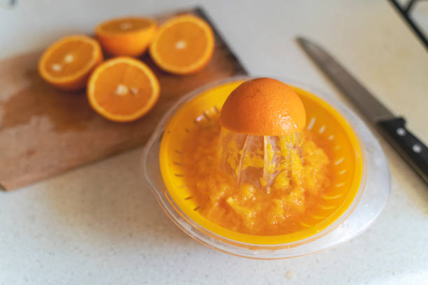 Orange in a squeezer to drink orange juice and get vitamin c