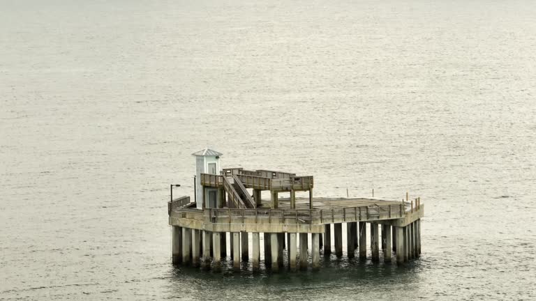 Aerial video of the old part of the Gulf Shores fishing pier in the Gulf of Mexico