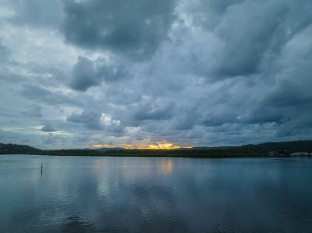 istock Autumn sunrise and rain clouds over the bay 1396937486