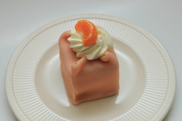 Fresh pink Marzipan confectionery with cream and tangerine