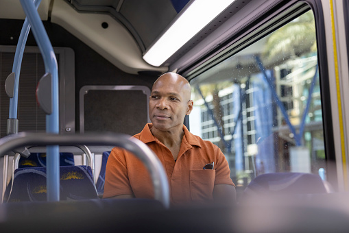 An African American man using public transport as part of his commute.