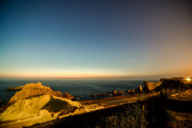 istock night sky over arnia playa beach, pielagos santander spain 1396938467