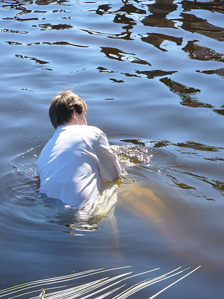 baptism by immersion in a lake stock photo