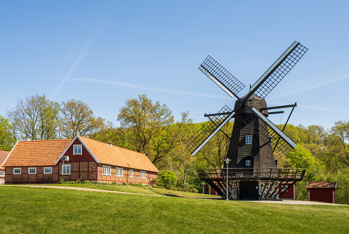 Astorp, Sweden - May 7, 2022: Perslund Park (Perslunds Hembygdsgård) housing local history collections and a old traditional old windmill.