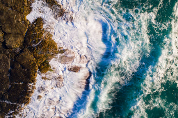 istock Top down view of ocean waves crashing onto shore 1396944491