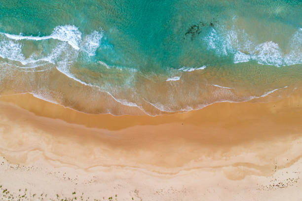 istock Turquoise blue water meeting empty beach 1396944649