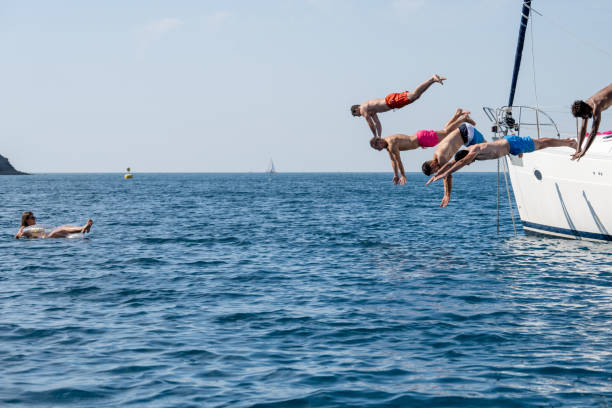 istock Several men jumping into water, enjoying party on yacht 1396945997