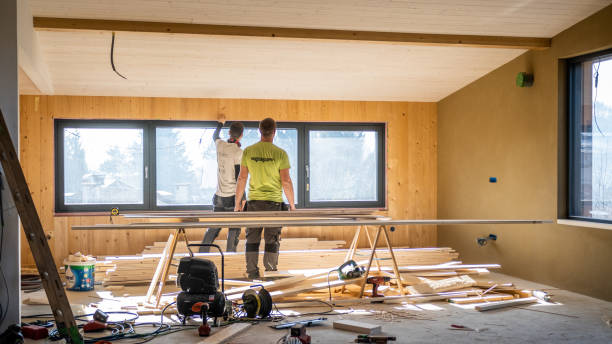 istock Workers making wooden lining of wall around window 1396946085