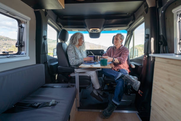 istock Retired couple eating meal inside luxurious customized camper van 1396946274