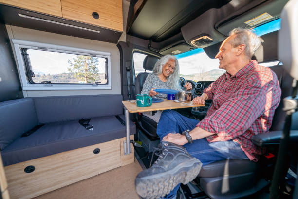 istock Active senior couple enjoying meal in customized camper van 1396946288