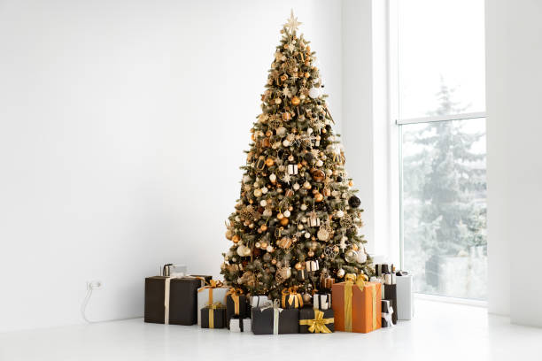 istock Christmas tree in white interior with stylish black and orange gift box 1396947031