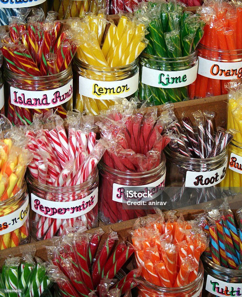 Stick Candy Brightly Colored stick candy in clear glass jars. Candy Stock Photo