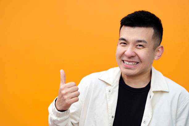 istock Cheerful Asian man gesturing thumb up 1396951539