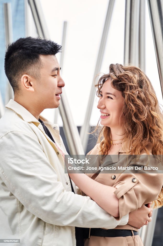 Closeup portrait of young lovely multiracial couple. People outdoors. Happy man and woman having fun in the city. Closeup portrait of young lovely multiracial couple. People outdoors. Happy man and woman having fun in the city. High quality photo 25-29 Years Stock Photo